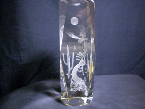 3D laser image of Kokopelli amidst cacti, with bir